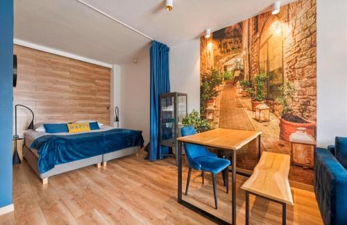 a bedroom with a bed and a table and a couch at Riverview Apartament Waterline SPA & Pool in Gdańsk