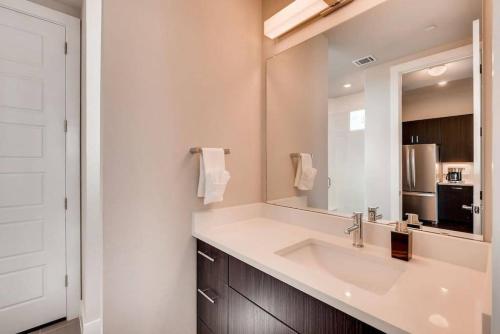 a bathroom with a sink and a mirror at Capitol View Condos - Downtown Austin - Lone Star in Austin