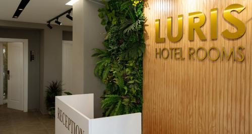 a lobby with a hotel room sign on the wall at Hotel Luris in Golem