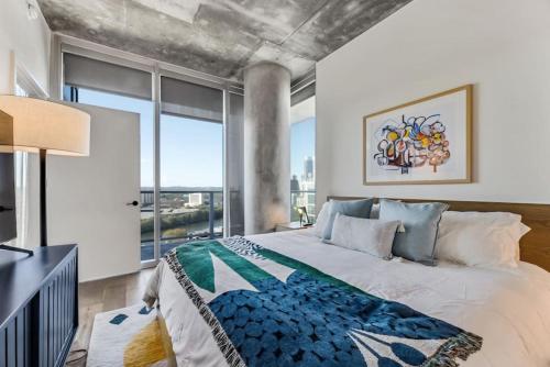 a bedroom with a large bed and a large window at 21st FL 2BD Condo-Rainey St-Best views in Austin