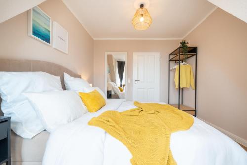 a bedroom with two white beds and a yellow blanket at CNSc422 - 2-Raum Appartement in Cappel-Neufeld