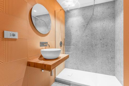 a bathroom with a bowl sink and a shower at Casa da Suite Sarpi in Milan