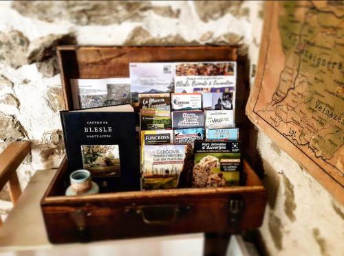 a suitcase full of books sitting next to a map at Gîte des fauvettes in Lorlanges