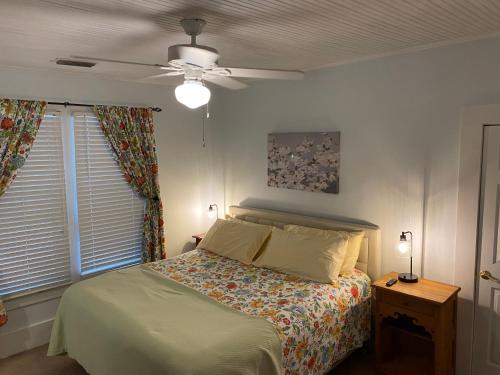 a bedroom with a bed and a ceiling fan at The Rose on Lakeside in Umatilla