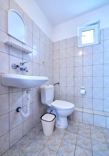 a bathroom with a sink and a toilet at Къща за гости Бор in Pomorie
