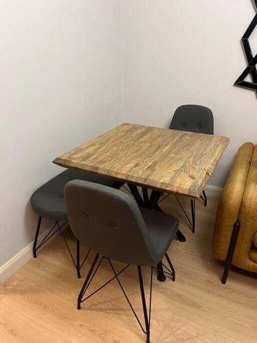 a wooden table with two chairs and a wooden table with at Cordonn residence apart city in Fethiye