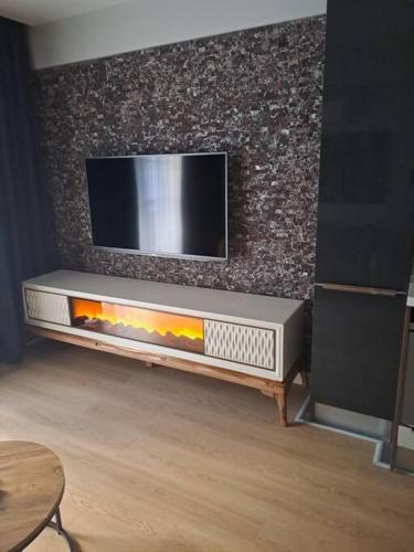 a living room with a tv on a wall at Cordonn residence apart city in Fethiye