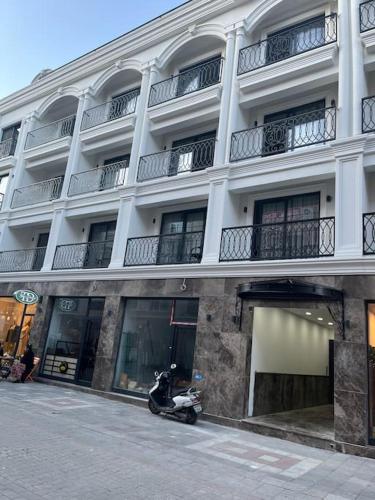 a scooter parked in front of a building at Cordonn residence apart city in Fethiye