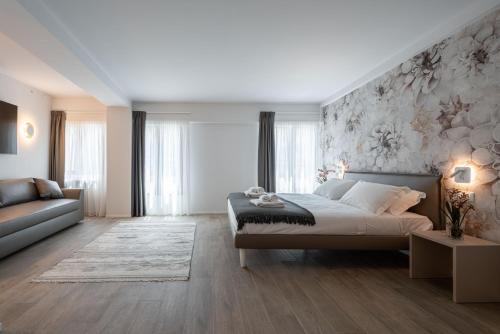 a bedroom with a large bed and a couch at Palace Canal View by Wonderful Italy in Venice