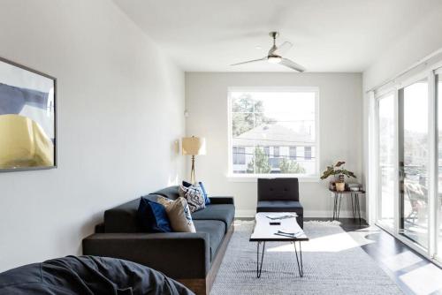 a living room with a couch and a table at Capitol View Condos by One Fine Bnb - Paramount in Austin