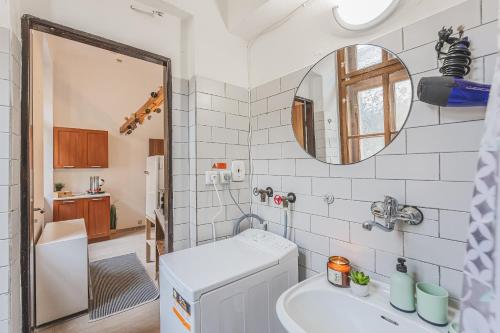 a small bathroom with a sink and a mirror at Carolina's CENTRAL Apartment in Hradec Králové