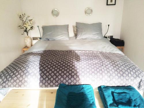 a bedroom with a large bed with two blue bags on the floor at The Quay Amsterdam - FREE PARKING in Amsterdam