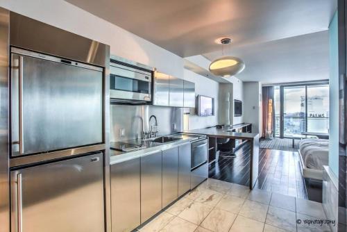 a kitchen with stainless steel appliances and a large window at Strip View - Luxurious Studio at Palms Place in Las Vegas