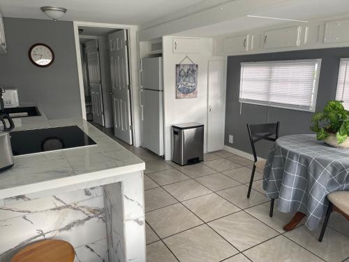 a kitchen and dining room with a table and a counter at Home in Arbor Terrace Resort in Bradenton