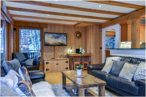a living room with a couch and a table at Chalet Chardonnet in Chamonix