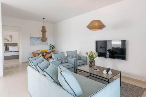 a living room with a couch and a table at Island Hills in Rhodes Town