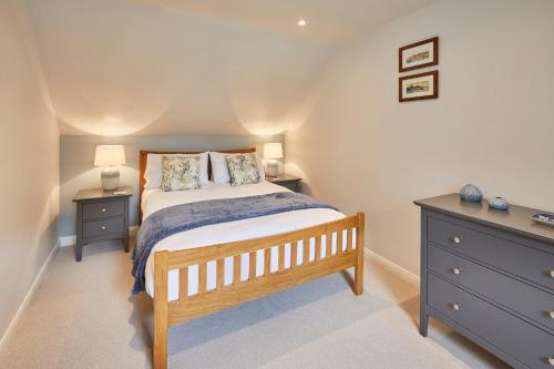 a bedroom with a bed with two night stands and a dresser at Host & Stay - Breckon Cottage in Whitby
