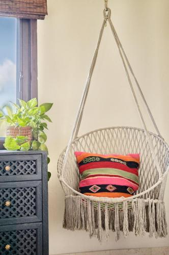 a hanging basket with a pillow in a room at The Aerial, BVI in Tortola Island