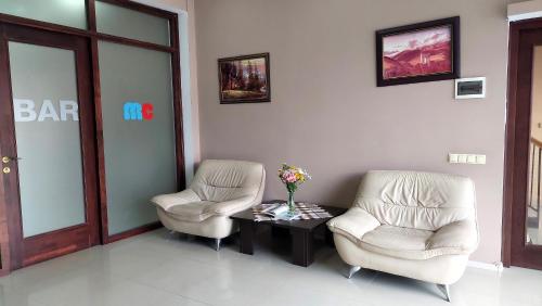 a waiting room with two chairs and a table at Hotel Max Comfort in Kutaisi