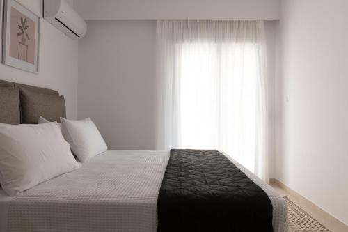 a bedroom with a large bed with a window at Island Hills in Rhodes Town