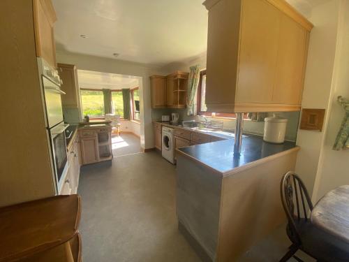 a kitchen with wooden cabinets and a counter top at Drummond House in Brackley