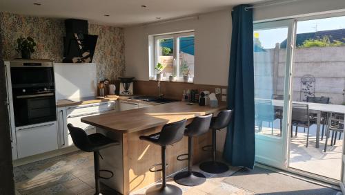 a kitchen with a wooden counter top and a table at Domaine des Gites du Nord - L'Intemporel - 4 à 5 chambres entre Lille, Arras et La Belgique in Chemy