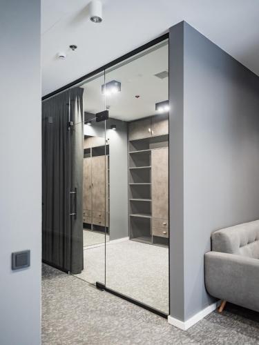 a sliding glass door leading to a walk in closet at City Inn Lviv Smart Hotel in Lviv