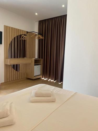 a room with two white towels on a bed at Kuburi Hotel in Ksamil