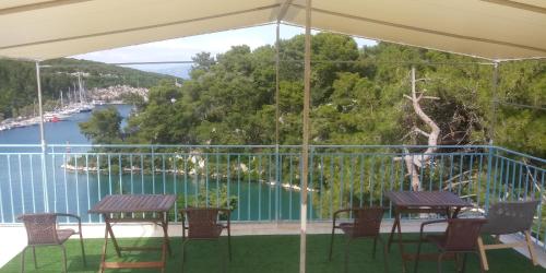 a balcony with tables and chairs and a view of the water at San Giorgio in Gaios
