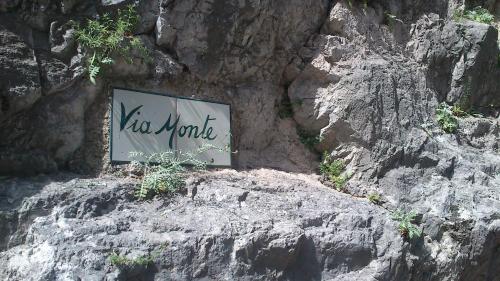 a sign on the side of a rocky mountain at Casa Giovanna Positano in Positano