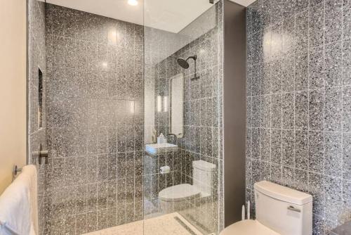 a bathroom with a shower with a toilet and a sink at Incredible View Of Downtown Walk To Rainey St in Austin