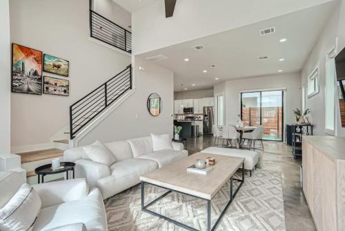 a living room with a white couch and a table at Grand Oasis At E Austin With Pool in Austin