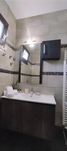 a bathroom with a sink and a mirror at Anna Maria Apartment in Skala Marion