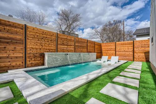 a swimming pool with chairs and a fence at Grand Oasis At E Austin With Pool in Austin