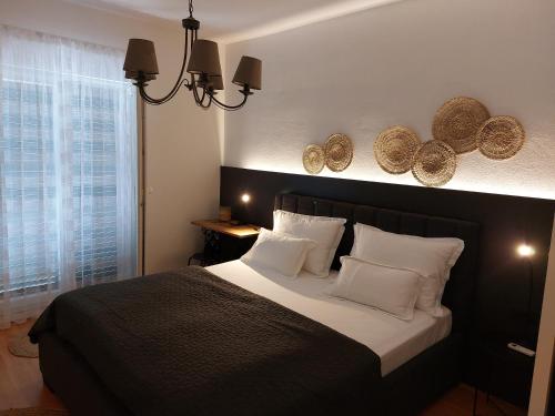 a bedroom with a large bed with white pillows at Villa Bacio with new heated pool in Brštanovo