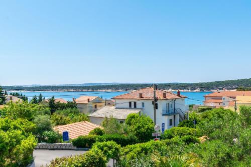 a view of a town and the water at Apartments Rada i Stanislav in Barbat na Rabu