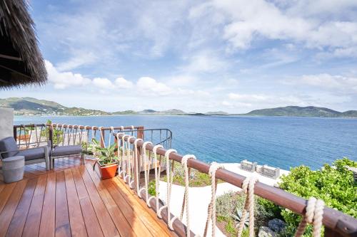 a balcony with a view of the water at The Aerial, BVI in Tortola Island