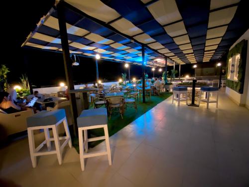 - un restaurant sur le toit avec des tables et des chaises la nuit dans l'établissement La Boutique Residence, à Hurghada