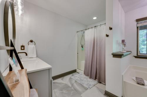 a white bathroom with a shower and a sink at Luxe Blairsville Cabin with Game Room, Near Hikes in Hood