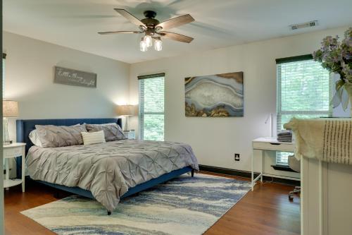 a bedroom with a bed and a ceiling fan at Luxe Blairsville Cabin with Game Room, Near Hikes in Hood