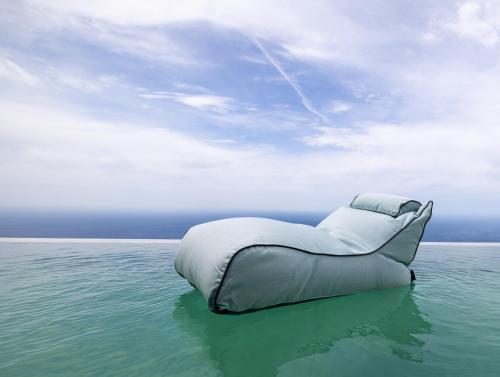 an inflatable bed in the middle of the ocean at Anadeo Villas & Suites in Exanthia