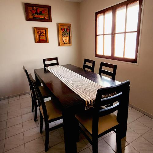 a dining room with a wooden table and chairs at Casa turismo Mendoza in Godoy Cruz