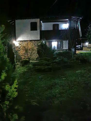 a house at night with lights in the yard at Къща за гости КИМ in Apriltsi
