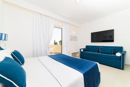 a bedroom with a bed and a blue couch at Residenza Al Pesce D'Oro in Amalfi