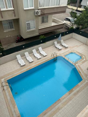 uma vista sobre uma grande piscina com espreguiçadeiras em Best Home City 1 em Alanya