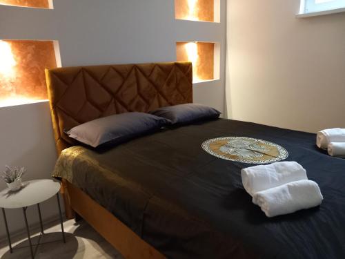 a bedroom with a bed with a blue comforter at Apartman 101 in Sarajevo