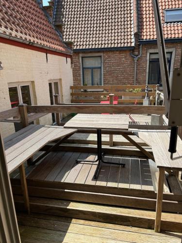 a picnic table on the deck of a house at Hotel Salvators in Bruges