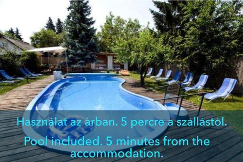 una gran piscina con sillas alrededor en Central Residence, en Sopron
