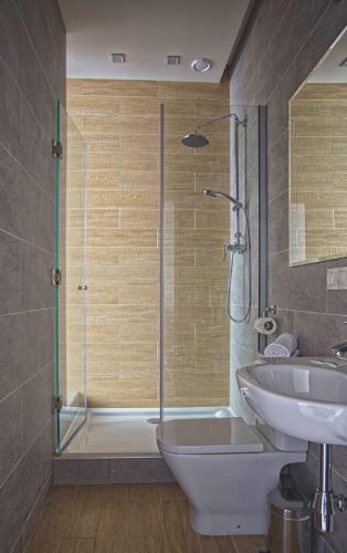 a bathroom with a shower and a toilet and a sink at Poet Art Hotel in Odesa