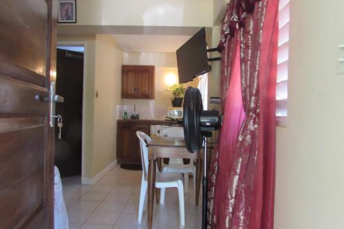 a kitchen with a table and chairs in a room at Nelsons Retreat in Negril